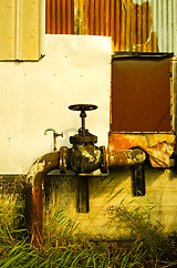 Patchwork wall and piping by the dock
