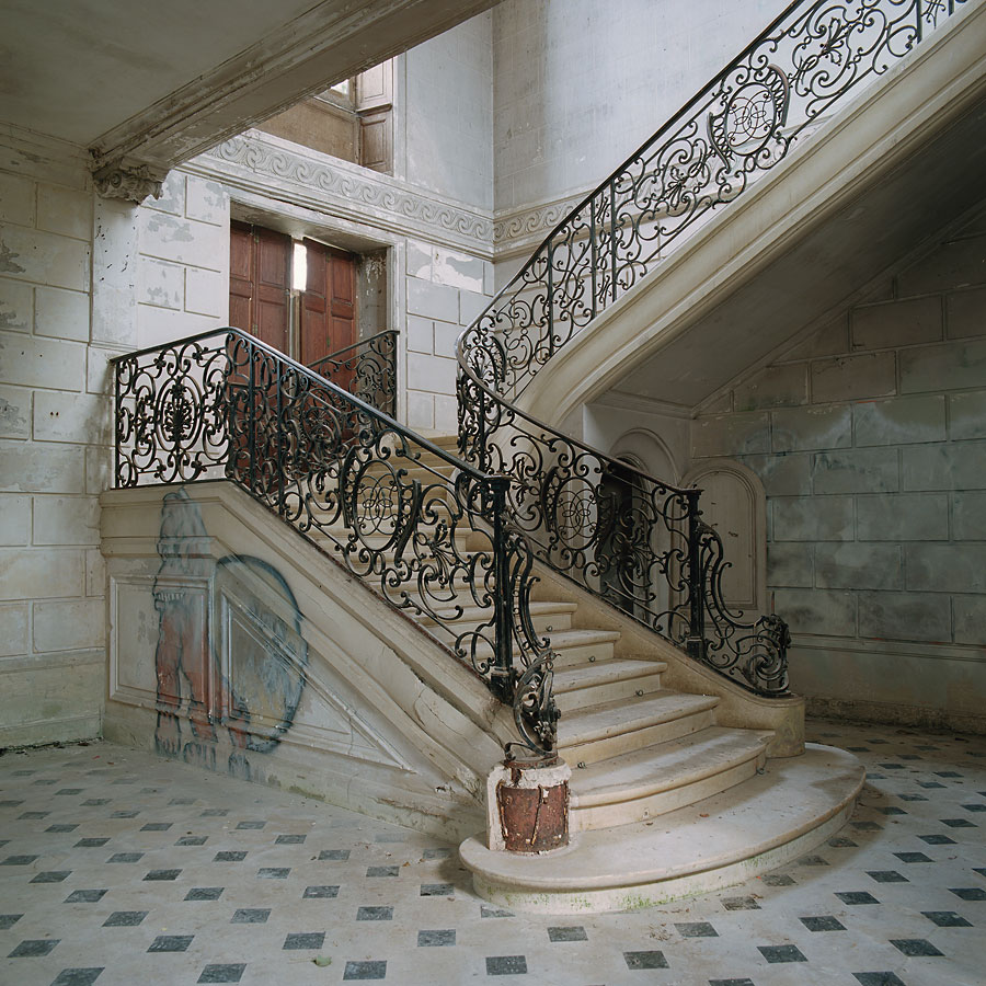 The famous stairway. The graffiti has been crossed out as a protest against scribbling in such an environment at Château of Singers, France.