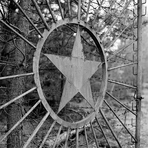 Gate with the ubiquitous star deco at Lychen II Sonderwaffenlager. Former DDR, Germany. October 2011.